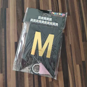 Close-up of FELIZ CUMPLEAÑOS gold foil letter M on black cardstock banner
