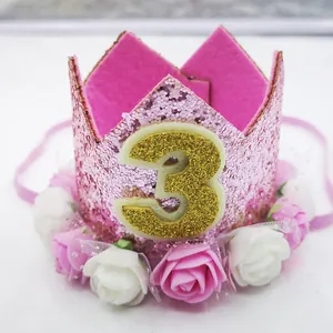 Macro detail of pink glitter 3rd birthday crown with roses and mesh for kids party