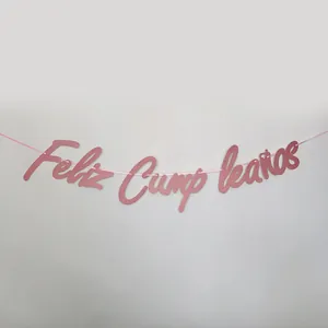 Close-up of pink glittery Feliz Cumpleaños banner for Spanish birthday party decor