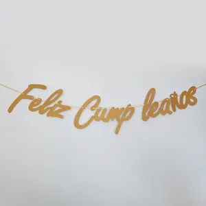 Close-up of golden glitter Feliz Cumpleaños birthday banner with cursive calligraphy detail