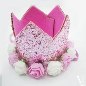 Detail of pink glitter baby crown with foam roses and elastic strap for party