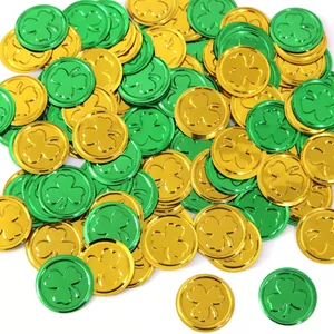 Pile of shiny gold and green plastic shamrock coins for St. Patrick's Day decorations