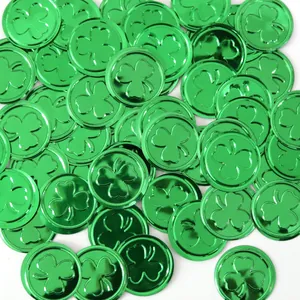 Close-up of metallic green St. Patrick's Day shamrock coins for party table decoration