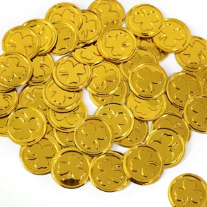 Close-up of shiny gold plastic shamrock coins for St. Patrick's Day party decorations