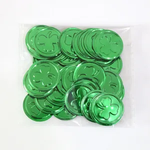 Close-up of green metallic shamrock coins for St. Patrick's Day party decor in a clear polybag