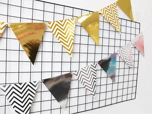 Detail of Nordic gold foil bunting flags with metallic waves and stripes on wall