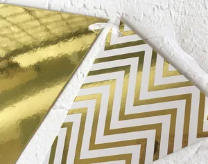 Close-up of gold and white wave pattern triangle bunting flags with hanging ribbon