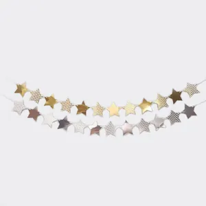 Detail of metallic gold and silver star bunting banner with elegant wave patterns