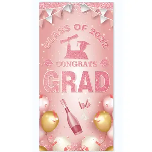 Detailed view of pink 2022 graduation banner with glitter text and balloon graphics