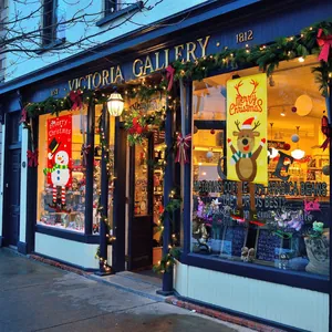 Detailed view of Christmas banners with snowman and reindeer hanging by shop window