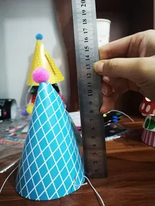 Mini birthday party hat size measurement showing height with a metal ruler