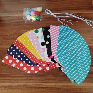 DIY party hat kit with colorful polka dot cards, pom poms and elastic strings for kids