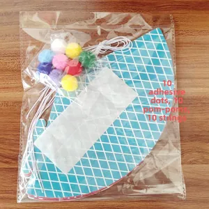 DIY birthday party hat kit containing 10 paper hats, colorful pom poms, and elastic strings