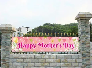 Detail of pink Mother's Day banner with balloons and flowers on a garden fence