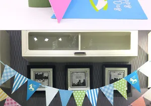 Detail of blue party bunting featuring polka dots, stripes, and cartoon rocking horse patterns