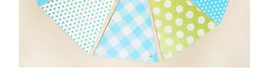 Detail of colorful party bunting flags with star and polka dot patterns for birthday decor