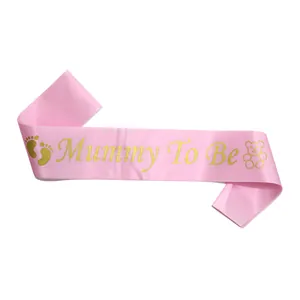 Detailed view of pink satin Mummy To Be sash with gold glitter text and cute icons
