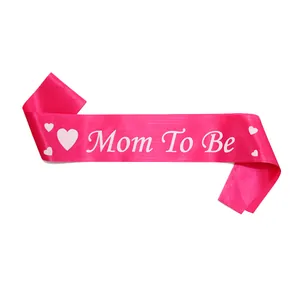 Detailed view of pink Mommy to Be satin sash with heart patterns for baby shower parties