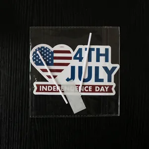 Detail of 4th of July party sign with heart flag and sticks in transparent packaging