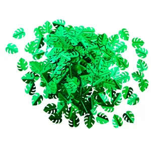 Confettis feuilles de monstera vert métallisé pour décoration de table de fête hawaïenne