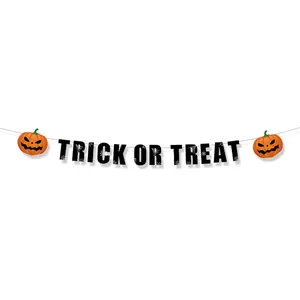 Detail of Trick or Treat banner with orange pumpkin accents and spider web patterns