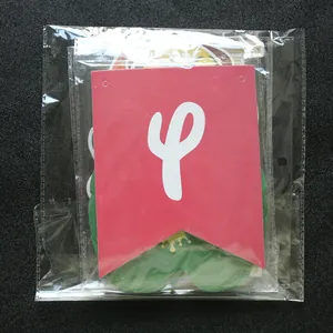 Detail of colorful flamingo party banners in transparent packaging on black surface