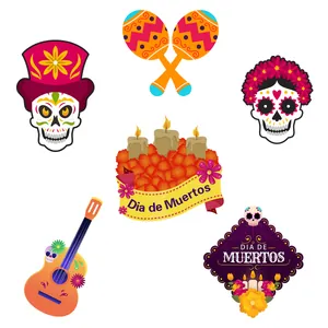 Close-up of Dia de Muertos hanging decorations with guitar, skull, and candle illustrations