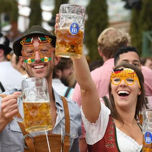 Detail of Oktoberfest party glasses with pretzel, beer mug and traditional hat decorations