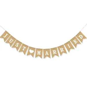 Close-up of Just Married burlap banner with dovetail flags and white heart print