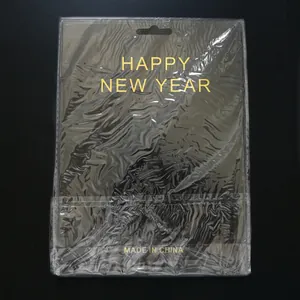 Detail view of Happy New Year gold foil banner in retail packaging with hanging hole