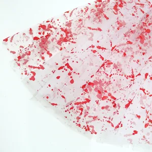 Detailed view of white mesh tutu skirt with realistic red blood splatter for Halloween