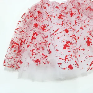 Detail of white Halloween tutu skirt with realistic red blood splatter on mesh fabric