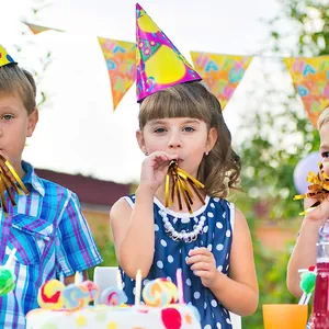 Children using colorful polka dot party hats and gold tassel blowouts at a birthday event