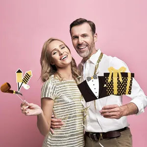 Macro shot of 2026 New Year party photo booth props with gold glitter festive motifs
