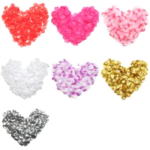 Multiple colors of fabric rose petals arranged in heart shapes for wedding decor
