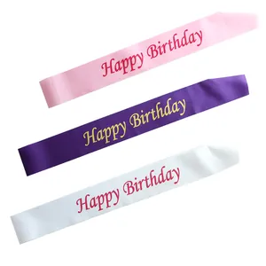 Detailed view of colorful satin Happy Birthday sashes in pink, purple and white