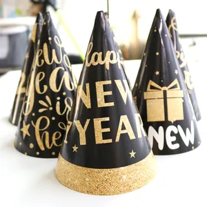 Set of black and gold Happy New Year party hats with festive glittery star patterns