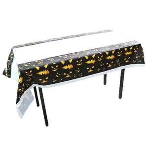 Detail of waterproof PE Halloween tablecloth featuring orange pumpkin faces on black border
