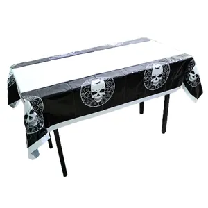 Close-up of Halloween table cloth featuring skull patterns and spider web details