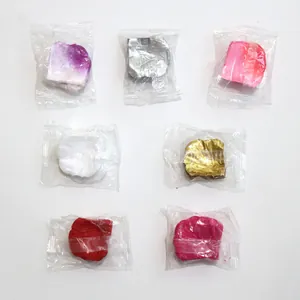 Detail view of multicolored artificial rose petals in individual clear plastic packaging