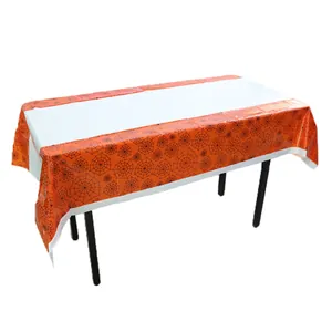 Detail of Halloween PE tablecloth showing orange spider web pattern on white background