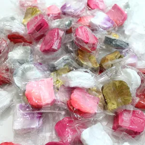 Detail view of bulk colorful artificial rose petals in individual clear plastic packaging