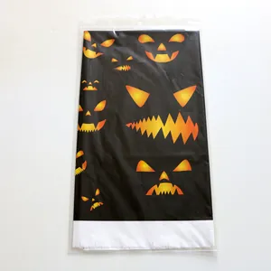 Halloween pumpkin party gift bag with orange jack-o-lantern prints on black plastic