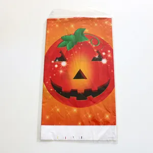 Detail of folded Halloween table cover with pumpkin face design in clear packaging