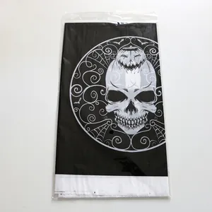 Detail of Halloween plastic gift bag with skull and pumpkin prints in white on black background