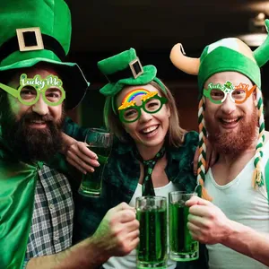 Three models wearing St. Patrick's Day party paper glasses in a pub setting