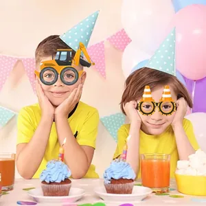 Children wearing yellow construction excavator party glasses at a birthday celebration