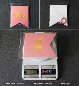 Pink Mother's Day banner set with gold crowns in retail packaging and product weight