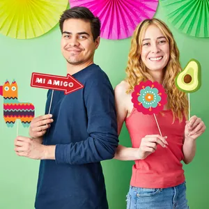 Vibrant Mexican fiesta photo booth props set with llama and avocado for party fun