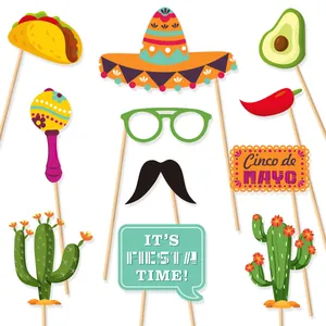 Detail of Cinco de Mayo photo booth props featuring tacos, cacti and maracas for fiesta parties